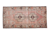 Distressed vintage Oushak runner, dusty mauve field, sand stepped double medallions, and brown border. 4' x 8'3