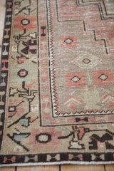 Distressed Oushak runner detail: border with meandering plant motifs and faded pile texture.