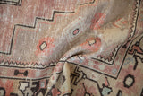 Textured pile of distressed Oushak runner, ram horn tendrils in dusty mauve and sand.
