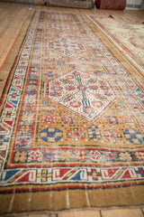 Meandering serpent main border with pinwheel geometric floral field on a time-softened antique Serab runner.