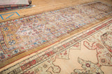 Worn antique Serab rug with geometric camel field and a meandering serpent border.