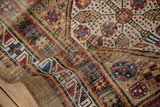 Antique Serab runner's hand-knotted pile, showcasing geometric medallions, wear, and side selvage.