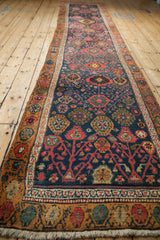 Vintage Bijar runner’s navy field displaying interconnected madder root red, saffron palmettes.
