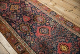 Interconnected madder red and navy blue palmettes on a hand-knotted vintage Bijar runner.
