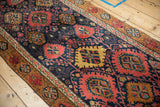 Navy field with serrated madder red palmettes and saffron yellow geometric border on Bijar runner.