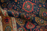 Hand-knotted vintage Bijar rug pile in navy, madder red, and gold palmette design.