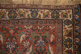 Detailed floral border and hand-knotted fringe on a vintage Persian Bijar rug corner.
