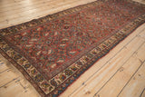Full length perspective of the vintage Persian Bijar runner's traditional Herati pattern.