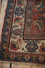 The worn selvedge and intricate floral borders of a vintage hand-knotted Bijar rug runner.