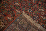 A folded corner of a vintage Bijar runner reveals its hand-knotted foundation and red Herati design pile.