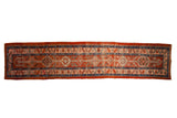 Antique Persian Heriz runner with interconnected medallions down a cherry red field with sapphire blue borders.