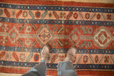 Low pile showing visible knot heads and foundation on a geometric antique Persian Heriz runner.