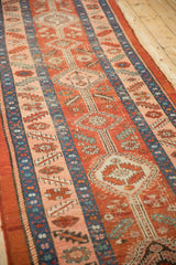 Antique Heriz runner viewed at an angle, showing its saturated cherry red and sapphire blue hues.