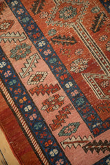Visible knot heads and vivid pink and sapphire blue wool on an antique Heriz runner.