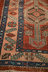 Close view of the worn knot heads and serrated leaf border on an antique Heriz rug.