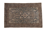 Distressed vintage Hamadan rug with a central medallion in dusty slate blue, silver, and charcoal.