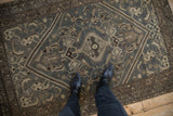 A personal perspective of the distressed low pile and slate blue tones of a vintage Hamadan rug.