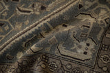 A folded view showing the even wear across the knot heads of a vintage distressed Hamadan rug.