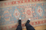 Evenly worn texture of a distressed Karaja runner with powder blue and dusty red geometric designs.