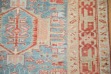 Evenly worn pile on a vintage Karaja runner with geometric hook details in powder blue and dusty red.