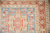 Geometric hook and latch detailing on the powder blue and dusty red corner of a Karaja runner.