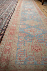 Low angle perspective of a long Karaja runner showing its time-softened blue and red design.