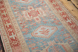 A Karaja rug's geometric blossoms and stepped medallion in dusty cherry red on a powder blue field.