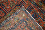 Folded corner of antique Heriz rug, revealing its hand-knotted foundation and pile.