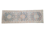 Distressed Bakhtiari runner, faded triple medallions, floral field in soft blues, rose, and ivory.