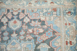 Distressed Bakhtiari runner detail, revealing worn floral motifs in sky blue, madder root, and ivory.