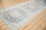Distressed Bakhtiari runner, low pile floral field in muted blues and dusty rose.