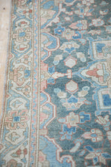 Distressed Bakhtiari runner border with floral Samovar motifs in blue, blush, and ivory.