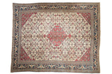 Vintage Khorassan carpet with a serrated red medallion and Herati design on an ivory field, framed by a dark navy blue border.
