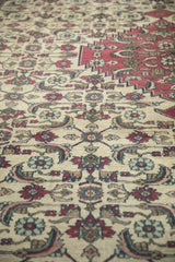 Angled view of the textured, low pile showing Herati motifs in dusty blue and red.