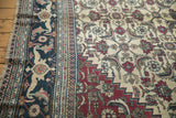 Close-up of the vintage Khorassan carpet's navy border with its Samovar Turtle motif.