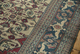 Angled view of the Khorassan's ivory Herati field and navy Samovar Turtle border detail.