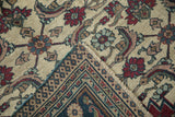 Folded corner of a vintage Khorassan carpet revealing the Herati pile and woven foundation.