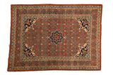 Antique Haji Jalili Tabriz rug with a rust Herati field, central starburst medallion, and navy blue spandrels.