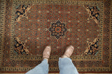 Showing the scale and intricate Herati design of an antique Haji Jalili Tabriz rug.