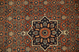 A starburst center medallion amid the dense Herati field of a finely knotted antique Haji Jalili Tabriz rug.
