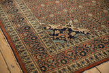Intricate Rococo-style corner spandrel and vine border on an antique Haji Jalili Tabriz rug.
