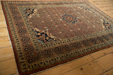 Antique Haji Jalili Tabriz rug showing the starburst medallion, corner spandrels, and rust field.