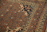 Rococo stylized leaves on the navy corner spandrel of an antique Haji Jalili Tabriz rug.