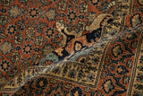 Dragon-stylized vine border and rust Herati field on a draped antique Haji Jalili Tabriz rug.