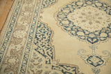 Curvilinear Safavid arabesque design on a vintage Tabriz rug in navy, beige, and seafoam.