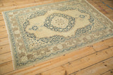 Vintage Tabriz rug corner with Safavid navy arabesque main border and beige motifs.