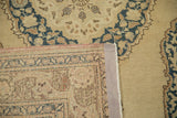Vintage Tabriz rug's beige pile, navy patterns, pink selvedge, and woven reverse.