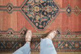 Mostly even wear and low-pile texture on an antique Persian Hamadan rug runner.