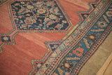 Serrated navy medallion and leaf motif border on an antique Hamadan's abrashed red field.