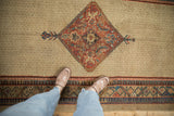 Antique Serab runner's central diamond medallion on a camel seeded lattice field.